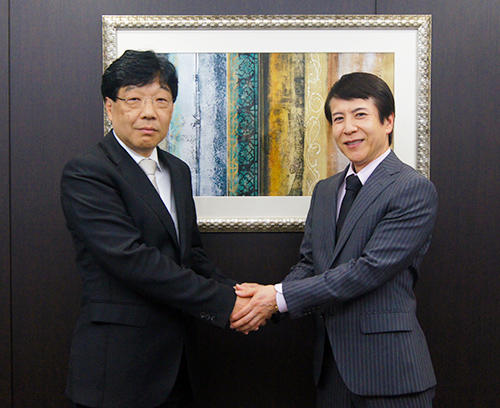 握手を交わすマルベニ質店の勝田守文社長（左）とグローバルトレードの牟田成会長